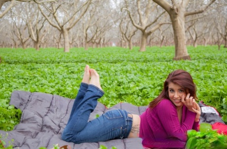 When Aubrey Chase goes to the park, she removes her purple sweater and displays it with her big boobs.