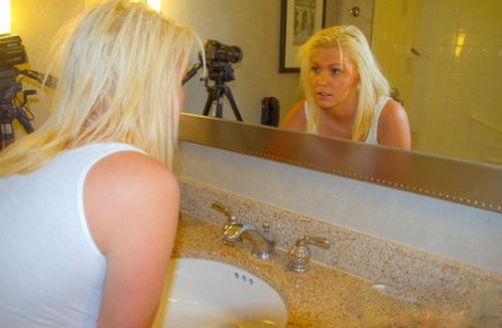 From a wet shirt, blonde amateur Brooke Alexander releases her sizable breasts.