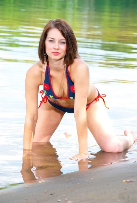 The lake was the setting for a hot, amateur-like woman in bikini tops with her knees exposed.