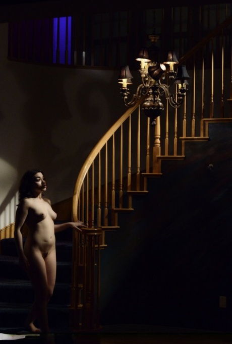 The dark staircase is where Asian model Angelina Mylee stands before her naked face.