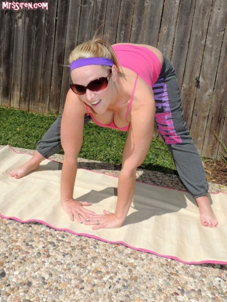 Dee Siren, a volunteer woman in a sweatpants, frees her large buttocks by the pool.