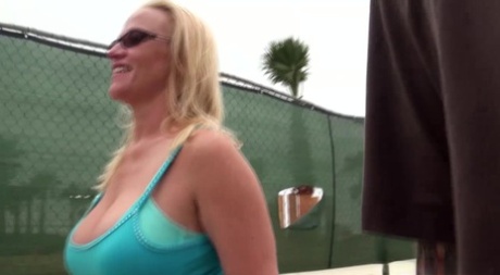 An overweight blonde named Dee Siren pissed behind a building before having sex in public.