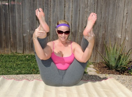 Dee Siren, a self-proclaimed amateur yoga enthusiast, displays her substantial buttocks while practicing yoga outside.