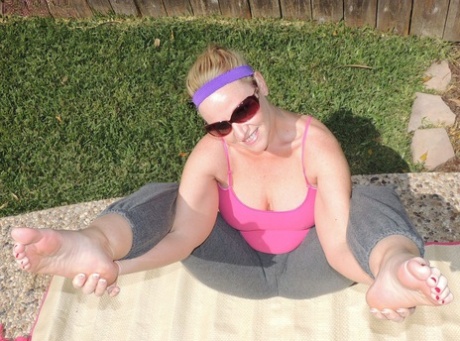 Self-proclaimed "Bad Chick" Dee Siren flaunts her large buttress while practicing yoga outside.