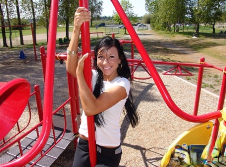 Trista Stevens, a dark-haired girl, lounging in a bikini on a playground.