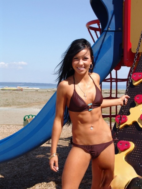 Trista Stevens, a blonde girl, lounges around in a bikini on a playground.