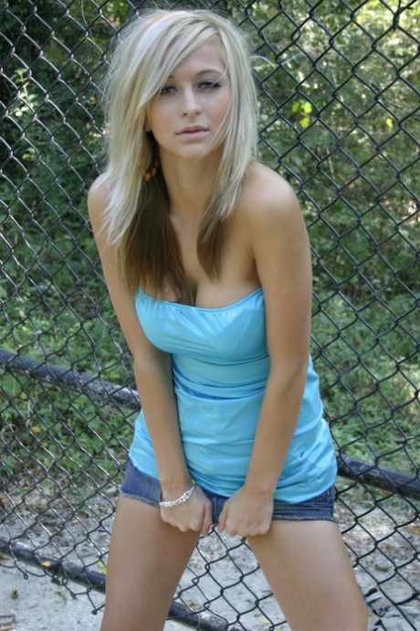 First time blonde London Hart puts on a denim skirt over her panties.