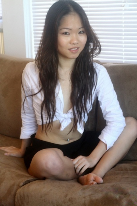 During a safe for work action, Grace, an Asian amateur, removes her halter top.