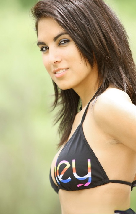 Rachel with her gorgeous dark hair and provocative outfit in a black bikini outdoors.