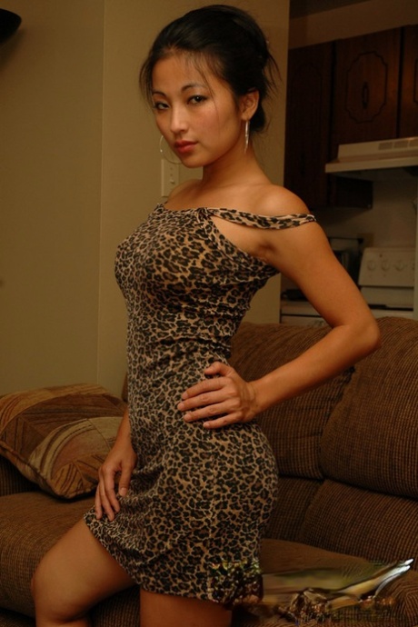 A seductive Asian amateur, Aria Lee flaunts her curves in a tight dress to exhibit her firm buttocks.