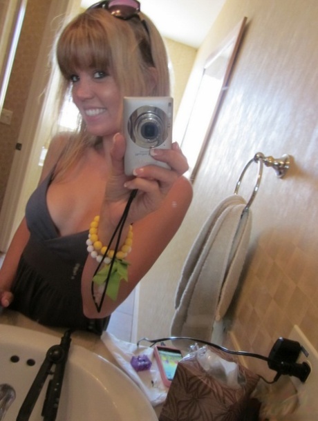 A cute young girl named Diddylicious takes selfies while wearing a topless toilet in the bathroom.
