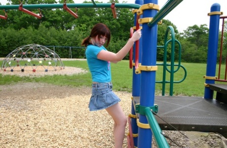 On the playground, Barbie with freckles displays her perky tits.
