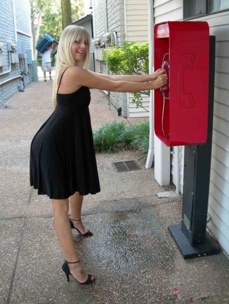 Blonde amateur Jana Jordan flashes her panties at a public phone