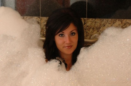 While taking a bubble bath, Brunette MILF Sweet Krissy showcases her toned and attractive body.