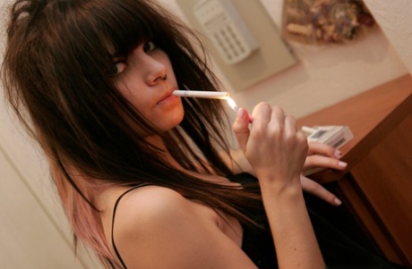 Petite teen Kaira 18 smokes a cigarette while getting naked in her bedroom - PornHugo.net