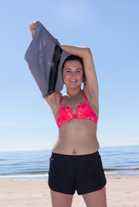 First timer Laimites spreads her hairy twat wide in the water on to catch some waves at the beach.