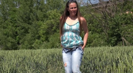 Older Brunette NicolD Whips Down Her Blue Jeans To Piss In The Tall Grass