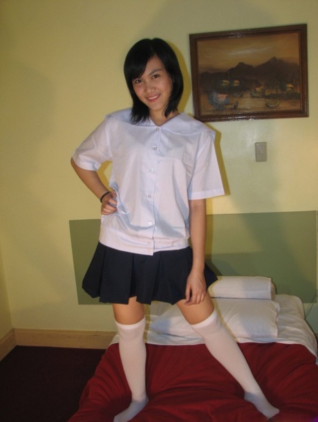 Asian Schoolgirl Exposes Upskirt Panties Before Getting Naked In OTK Socks