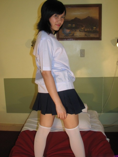 Asian Schoolgirl Exposes Upskirt Panties Before Getting Naked In OTK Socks