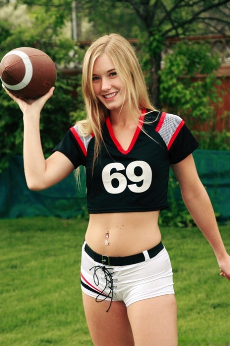 While holding a football, Jewel's beautiful blonde hair allowed her to pose in nude.