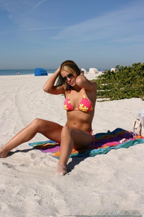 Teen solo girl Karen relaxes at the beach in a bikini and sunglasses