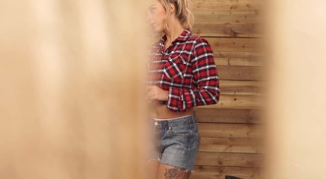 During her horse stall cleaning, Louise, a stunning blonde, exposes her large tits.