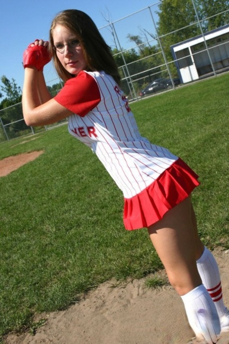 Sporty teen shows her bra and cleavage in a micro skirt baseball uniform