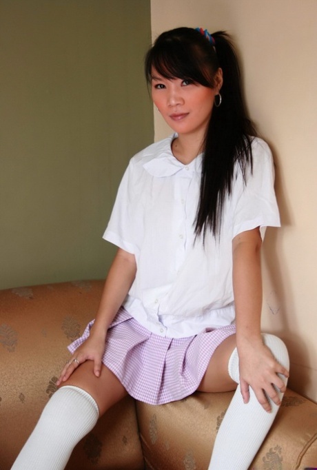 Asian teen Carla touches her breasts and pussy in over the knee socks