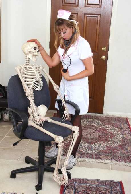 Sexy Nurse Christy James Peels Her White Uniform To Facesit On A Skeleton