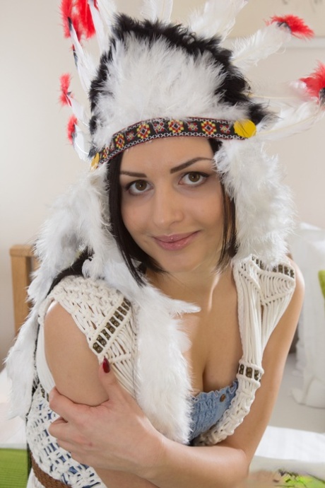 Brunette Teen Wears An Indian Headdress While Disrobing For Nude Poses