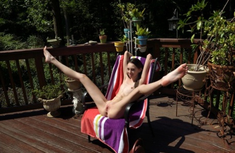 Skinny teen girl Aria Haze takes off her bikini and pegs her twat on patio