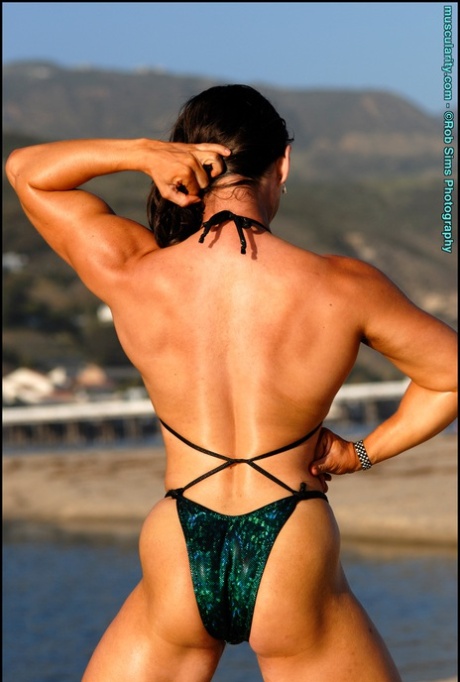 Bodybuilder Lada Phihalova Flexes Her Muscles On A Beach In A Bikini