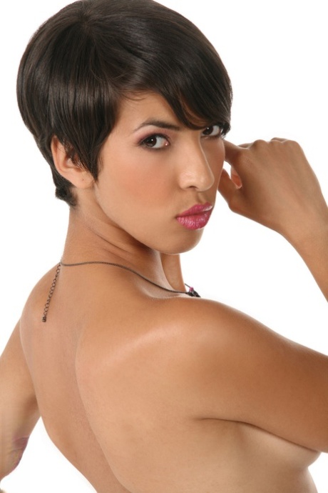 Jasmine Arabia, a short-haired Latina, displays her femininity by wearing satin lingerie and sheer hosiery.