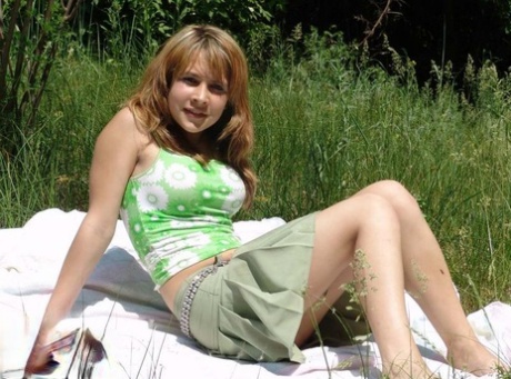 Sweet young teen Liza revealing her firm perky boobs on a blanket in the grass