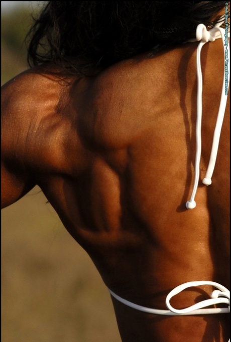 Bodybuilder Deidre Pagnanelli exhibits her muscular physique while wearing a bikini.