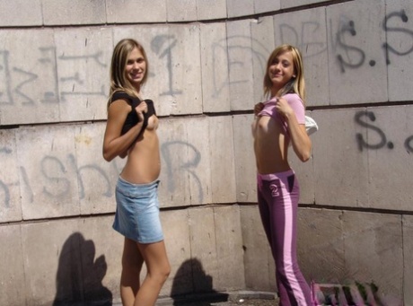 Cute teen lesbians flash their small tits while walking down the road