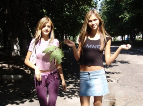 Cute teen lesbians flash their small tits while walking down the road