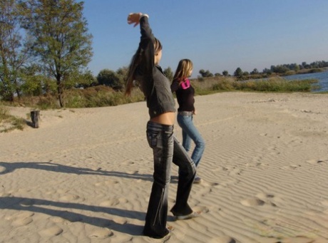 While at the beach, Lauraa and Katrina, two young lesbians, reveal their tiny tits.