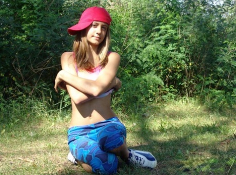 Blonde Teen Goes To Lift Up Her Tank Top With Her Ball Cap On Sideways