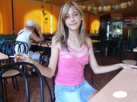 Dirty blonde teen flashes a no panty upskirt inside a restaurant