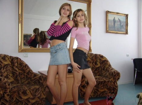 Teen lesbians Laura & Katrina display their small tits after getting naked