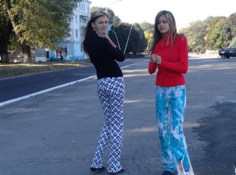Teenager lesbians Laura and Katrina flaunt their tits and buttocks while out and about.