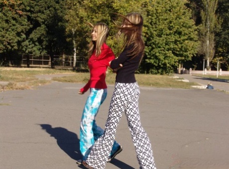 Teen lesbians Laura & Katrina flash their tits and butts while wandering about