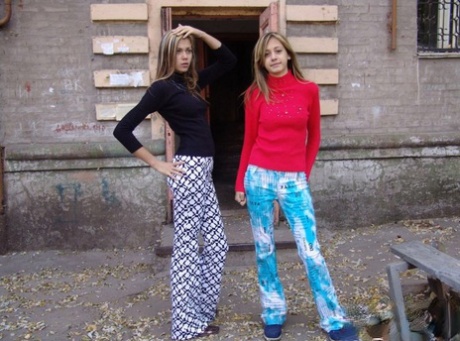 Teen lesbians Laura & Katrina flash their tits and butts while wandering about
