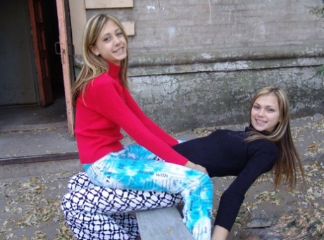 Teen lesbians Laura & Katrina flash their tits and butts while wandering about