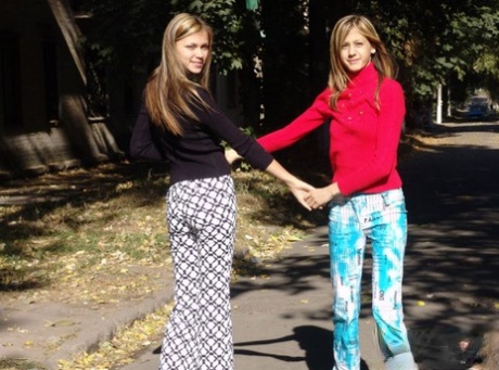 As teenage lesbians, Laura and Katrina display their tits and buttocks while wandering around.