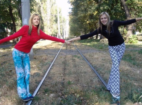 Teen lesbians Laura & Katrina flash their tits and butts while wandering about
