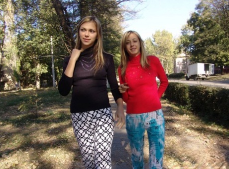 Teen lesbians Laura & Katrina flash their tits and butts while wandering about