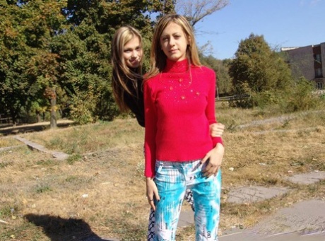 Teen lesbians Laura & Katrina flash their tits and butts while wandering about