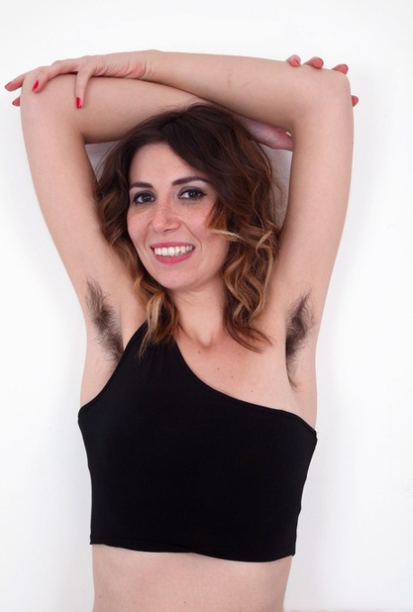 Hairy girl Terri Rose displays a wide open pussy with hair on her legs.